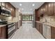 Spacious kitchen with stainless steel appliances, granite countertops, and tiled floors at 604 Oak Blvd W Dr, Greenfield, IN 46140