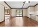 Open living space boasting hardwood floors and an adjacent outdoor deck entrance at 604 Oak Blvd W Dr, Greenfield, IN 46140