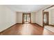 Bright living room featuring hardwood floors, a large window, and an open entryway at 604 Oak Blvd W Dr, Greenfield, IN 46140