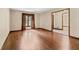 Bright living room featuring hardwood floors, a large window, and an open entryway at 604 Oak Blvd W Dr, Greenfield, IN 46140