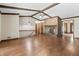 Living room featuring hardwood floors, a brick fireplace, exposed beams, and an open layout for entertaining at 604 Oak Blvd W Dr, Greenfield, IN 46140
