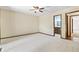 Carpeted main bedroom with ceiling fan and ensuite bathroom, offering comfort and convenience at 604 Oak Blvd W Dr, Greenfield, IN 46140