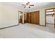 Main bedroom with carpet, ceiling fan, and access to two separate closets for organized storage at 604 Oak Blvd W Dr, Greenfield, IN 46140