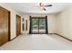 Bright main bedroom with carpet, ceiling fan, and access to the deck through sliding glass doors at 604 Oak Blvd W Dr, Greenfield, IN 46140