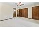 Spacious main bedroom with carpet, ceiling fan, and multiple closets for ample storage at 604 Oak Blvd W Dr, Greenfield, IN 46140