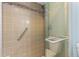 Shower showcasing a grab bar, a tiled shower, and a hand-held shower head at 604 Oak Blvd W Dr, Greenfield, IN 46140