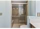 Modern shower featuring a grab bar, bench seat, and elegant tile work at 604 Oak Blvd W Dr, Greenfield, IN 46140