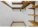 A well organized walk-in closet with shelving and a hanging rod for optimal storage at 604 Oak Blvd W Dr, Greenfield, IN 46140