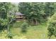 Brick home featuring a deck and a large, grassy, fenced yard surrounded by mature trees at 604 Oak Blvd W Dr, Greenfield, IN 46140