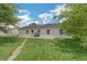 Exterior view of the home with a spacious backyard and green lawn at 609 Willow Dr, Shelbyville, IN 46176