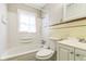 Bright bathroom featuring a tiled bathtub, shower, and a classic vanity with white cabinets at 609 Willow Dr, Shelbyville, IN 46176