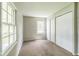 Bright bedroom with neutral carpeting, light walls, and closet, creating a serene space at 609 Willow Dr, Shelbyville, IN 46176