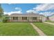 Charming single-story home with a welcoming front porch and well-maintained lawn at 609 Willow Dr, Shelbyville, IN 46176