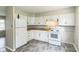 Efficient kitchen featuring white appliances, ample cabinet space, and modern flooring at 609 Willow Dr, Shelbyville, IN 46176