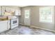 Functional kitchen with white cabinetry, an electric stove, and modern flooring at 609 Willow Dr, Shelbyville, IN 46176