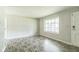 Bright living room features gray walls, modern flooring, and a large window for ample natural light at 609 Willow Dr, Shelbyville, IN 46176