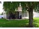 Expansive backyard featuring a covered patio area and mature tree providing shade for relaxation at 6161 E Runnymede Ct, Camby, IN 46113
