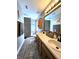 Bathroom offers a double sink vanity, modern floors, and a shower-tub combination at 6161 E Runnymede Ct, Camby, IN 46113