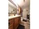 A cozy bathroom features a wood vanity and rustic decorations at 6161 E Runnymede Ct, Camby, IN 46113