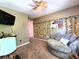 A cozy sitting area with soft chair, string lights, carpet, and ceiling fan at 6161 E Runnymede Ct, Camby, IN 46113