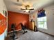 An exercise room features carpet, a ceiling fan, and a work out bench at 6161 E Runnymede Ct, Camby, IN 46113
