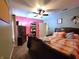 A colorful bedroom features a large bed and pink accent wall at 6161 E Runnymede Ct, Camby, IN 46113