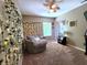 Relaxing bedroom design with soft carpet, a cozy papasan chair, and decorative fairy lights at 6161 E Runnymede Ct, Camby, IN 46113