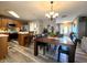 Open-concept dining area connected to the kitchen featuring modern lighting and a breakfast bar at 6161 E Runnymede Ct, Camby, IN 46113