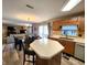 Open-concept kitchen with stainless steel appliances, wood cabinets, and a dining area at 6161 E Runnymede Ct, Camby, IN 46113