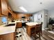 Kitchen boasts wood cabinets, stainless appliances, and a functional center island with seating at 6161 E Runnymede Ct, Camby, IN 46113