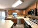 Well-equipped kitchen featuring ample counter space, stainless appliances, and warm wood cabinetry at 6161 E Runnymede Ct, Camby, IN 46113
