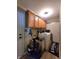 A compact laundry room with washer, dryer, cabinets and decorative accents at 6161 E Runnymede Ct, Camby, IN 46113