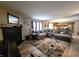 Comfortable living room with an attractive fireplace, an attractive area rug, and gray sofas at 6161 E Runnymede Ct, Camby, IN 46113