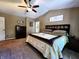 The main bedroom offers a ceiling fan, carpeted floors, and a full-size bed at 6161 E Runnymede Ct, Camby, IN 46113