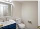 Half bathroom featuring a blue vanity with marble top and modern fixtures at 6465 Robinsrock Dr, Indianapolis, IN 46268