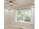 Bright bedroom featuring a ceiling fan and large window with white curtains at 6465 Robinsrock Dr, Indianapolis, IN 46268