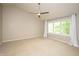Bright bedroom with ample natural light, neutral walls, and a ceiling fan at 6465 Robinsrock Dr, Indianapolis, IN 46268