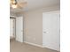 Cozy bedroom showcasing closet doors and neutral walls and carpet at 6465 Robinsrock Dr, Indianapolis, IN 46268