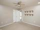 Cozy bedroom with neutral walls, carpet, ceiling fan, and doorway and shelving, offering a relaxing retreat at 6465 Robinsrock Dr, Indianapolis, IN 46268
