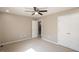 Comfortable bedroom features a ceiling fan, double door closet, and neutral walls and carpet at 6465 Robinsrock Dr, Indianapolis, IN 46268