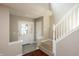 Bright foyer featuring a staircase, high ceilings, and a view of the front door with glass panes at 6465 Robinsrock Dr, Indianapolis, IN 46268