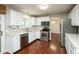Bright kitchen featuring white cabinets, stainless steel appliances, and a stylish backsplash at 6465 Robinsrock Dr, Indianapolis, IN 46268