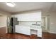 Spacious kitchen offers white cabinets, stainless steel refrigerator, and wood flooring at 6465 Robinsrock Dr, Indianapolis, IN 46268