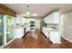 Modern kitchen featuring white cabinets, stainless steel appliances, and hardwood floors throughout at 6465 Robinsrock Dr, Indianapolis, IN 46268