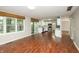 Bright and spacious living area with hardwood floors, natural light, and a view of the kitchen at 6465 Robinsrock Dr, Indianapolis, IN 46268