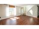 Open living room with hardwood floors, natural light, and a view of the entrance and staircase at 6465 Robinsrock Dr, Indianapolis, IN 46268