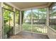 Cozy screened-in porch with wooded deck overlooking the backyard at 6465 Robinsrock Dr, Indianapolis, IN 46268