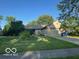 Charming single-story home featuring an attached two-car garage and a well-maintained lawn at 7231 N Orchard Dr, Indianapolis, IN 46236