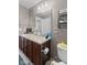 Bathroom with double sinks and dark wood cabinets at 7350 Gold King Way, Indianapolis, IN 46259