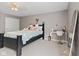 Bright bedroom with carpet, ceiling fan, and a desk space at 7350 Gold King Way, Indianapolis, IN 46259